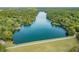 Aerial view of lake surrounded by dense, green trees and lakeside homes at 4126 E Rembrandt Dr, Martinsville, IN 46151