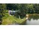 Breathtaking aerial view of lakefront home with a private dock, lush greenery, and stunning water views at 4126 E Rembrandt Dr, Martinsville, IN 46151