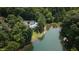 Scenic aerial shot of lake home nestled amidst trees, with a private dock on the serene waterfront at 4126 E Rembrandt Dr, Martinsville, IN 46151