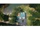 Overhead view showcasing the roof, driveway, and surrounding landscape of a private lake home at 4126 E Rembrandt Dr, Martinsville, IN 46151