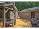 Backyard features a stone outdoor kitchen and dining space for alfresco enjoyment in nature at 4126 E Rembrandt Dr, Martinsville, IN 46151