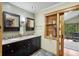 Elegant bathroom featuring a double vanity, framed mirrors, and decorative accents, blending comfort and style at 4126 E Rembrandt Dr, Martinsville, IN 46151