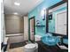 Bathroom featuring a blue glass bowl sink, a decorative mirror and a tub with shower at 4126 E Rembrandt Dr, Martinsville, IN 46151