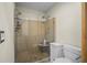 Modern bathroom features a glass-enclosed shower, toilet, and neutral color scheme at 4126 E Rembrandt Dr, Martinsville, IN 46151
