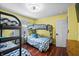 Bedroom with bunk beds, hardwood floors and warm yellow walls at 4126 E Rembrandt Dr, Martinsville, IN 46151