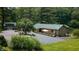 Charming brick home with a circular driveway, manicured landscaping, and additional outbuilding on property at 4126 E Rembrandt Dr, Martinsville, IN 46151