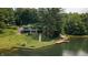 Beautiful lake house with a wooden dock, stone steps, and a well-manicured lawn, nestled by the water at 4126 E Rembrandt Dr, Martinsville, IN 46151