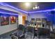 Home theater with plush seating, modern projector, and ambient blue lighting for a cinematic experience at 4126 E Rembrandt Dr, Martinsville, IN 46151