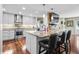 Modern kitchen with stainless steel appliances, granite countertops, sleek cabinetry, and adjacent bar seating area at 4126 E Rembrandt Dr, Martinsville, IN 46151