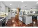 Bright kitchen featuring stainless appliances, granite counters, white cabinetry, and a seamless transition to the living room at 4126 E Rembrandt Dr, Martinsville, IN 46151