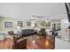 Comfortable open-concept living area features hardwood floors, modern lighting, and seamless transition to kitchen area at 4126 E Rembrandt Dr, Martinsville, IN 46151