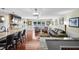Comfortable open-concept living area features hardwood floors, modern lighting, and seamless transition to kitchen area at 4126 E Rembrandt Dr, Martinsville, IN 46151