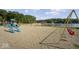 Community playground featuring multiple play structures and swings near a serene lake at 4126 E Rembrandt Dr, Martinsville, IN 46151