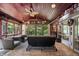 Inviting sunroom with wood ceiling, ceiling fan and lovely views of the outdoors from cushioned chairs and sofa at 4126 E Rembrandt Dr, Martinsville, IN 46151