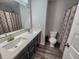 Well-lit bathroom with a double sink vanity, large mirror, and a patterned shower curtain at 4216 Lauder Rd, Bargersville, IN 46106