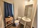 Cozy half bathroom with pedestal sink, toilet, and decorative storage cabinet for guests at 4216 Lauder Rd, Bargersville, IN 46106