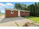 Brick house backyard features green grass and a concrete patio at 4221 Haverhill Dr, Anderson, IN 46013