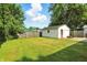 Spacious backyard features a well-maintained lawn and a detached one-car garage at 4221 Haverhill Dr, Anderson, IN 46013