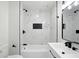 Modern bathroom features marble tile, black hardware, and a bathtub-shower combination at 4221 Haverhill Dr, Anderson, IN 46013