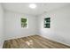 Bright bedroom with wood floors and windows offering a view of the trees at 4221 Haverhill Dr, Anderson, IN 46013