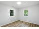 Bright bedroom features two windows with green tree views at 4221 Haverhill Dr, Anderson, IN 46013