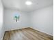 Light-filled bedroom with wood flooring, one window and white walls at 4221 Haverhill Dr, Anderson, IN 46013