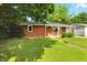 Charming single-story brick home with well-manicured front yard and mature trees at 4221 Haverhill Dr, Anderson, IN 46013