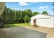 Detached garage with a white exterior and a spacious driveway at 4221 Haverhill Dr, Anderson, IN 46013