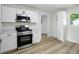 Stylish kitchen with white cabinets, stainless steel appliances, and laminate floors at 4221 Haverhill Dr, Anderson, IN 46013