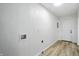 Bright laundry room with white walls and wood floors; washer hookups are visible at 4221 Haverhill Dr, Anderson, IN 46013