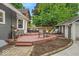 Outdoor living space with patio, garden, seating, and mature trees at 4732 N Kenwood Ave, Indianapolis, IN 46208