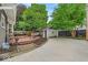Charming backyard featuring a wooden deck, ample seating, and a detached garage at 4732 N Kenwood Ave, Indianapolis, IN 46208