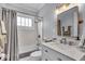 Updated bathroom with modern vanity, marble countertops, and shower-tub combination at 4732 N Kenwood Ave, Indianapolis, IN 46208