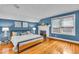 Comfortable bedroom featuring hardwood floors, light-colored walls, and a charming fireplace at 4732 N Kenwood Ave, Indianapolis, IN 46208