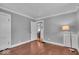 Cozy bedroom with decorative ceiling, hardwood floors, and an open doorway at 4732 N Kenwood Ave, Indianapolis, IN 46208