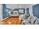 Spacious bedroom with hardwood floors, a ceiling fan, fireplace, and a sitting area at 4732 N Kenwood Ave, Indianapolis, IN 46208