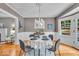 Charming dining room with modern lighting, light-colored walls, and hardwood floors at 4732 N Kenwood Ave, Indianapolis, IN 46208