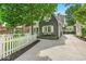Charming home featuring a white picket fence, beautiful stonework, and a long concrete driveway at 4732 N Kenwood Ave, Indianapolis, IN 46208