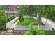 Inviting front yard view with a green lawn, white picket fence, and lush tree providing shade at 4732 N Kenwood Ave, Indianapolis, IN 46208