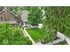 Charming home boasts a well-manicured front yard enclosed by a classic white picket fence and adorned with mature trees at 4732 N Kenwood Ave, Indianapolis, IN 46208