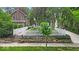 The home's front yard featuring a stone retaining wall, tidy landscaping, and a classic white picket fence at 4732 N Kenwood Ave, Indianapolis, IN 46208
