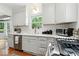 A bright kitchen with white cabinetry, subway tile backsplash, and stainless steel appliances at 4732 N Kenwood Ave, Indianapolis, IN 46208