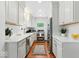 Charming kitchen featuring white cabinets, stainless steel appliances and hardwood floors at 4732 N Kenwood Ave, Indianapolis, IN 46208