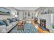 Comfortable living room features hardwood floors, a decorative fireplace, and plush seating at 4732 N Kenwood Ave, Indianapolis, IN 46208