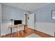 Study featuring hardwood floors, blue wallpaper, and white wainscoting at 4732 N Kenwood Ave, Indianapolis, IN 46208