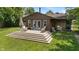 Backyard featuring a wooden deck, green grass, and chairs at 4742 Kingsley Dr, Indianapolis, IN 46205