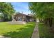 Backyard featuring a wooden deck, green grass, and a walkway at 4742 Kingsley Dr, Indianapolis, IN 46205