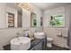 Modern bathroom featuring double sinks, large mirrors, and ample counter space at 4742 Kingsley Dr, Indianapolis, IN 46205
