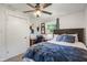 Bedroom with a ceiling fan, neutral walls, carpet, and natural light from the windows at 4742 Kingsley Dr, Indianapolis, IN 46205