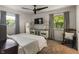 Bright bedroom with neutral colors, carpet floors, a ceiling fan, and natural light from the window at 4742 Kingsley Dr, Indianapolis, IN 46205